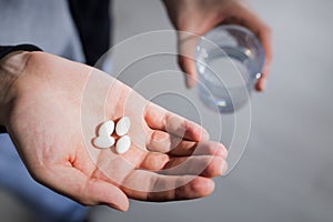 Four pills in palm