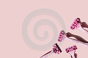 Four pink women\'s razors on a pink background photo