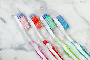 Four plastic colored toothbrushes
