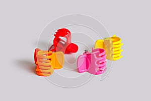 Four plastic hair clips on a light background