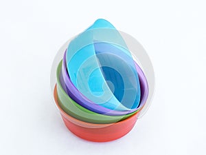 Four plastic round medium size bowls for loose products isolated on a white background