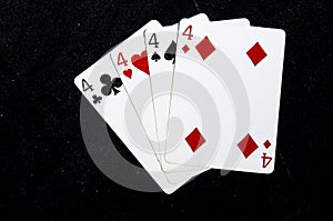 Four playing card`s fanned out all fours