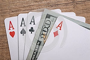 Four poker aces with dollar bills