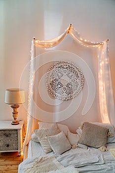 The four-poster bed in pastel colours. backlight.