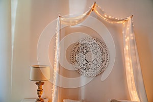 The four-poster bed in pastel colours. backlight.