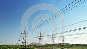 Four power energy lines of high-voltage transmission pylons with industrial background and clear blue sky. Illustration