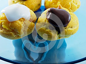 Four profiterole close up with cream and chocolate photo