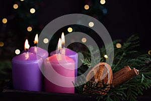 Four purple advent candles in Christmas eve