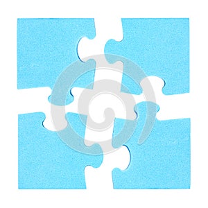 Four puzzle pieces combined cooperation concept