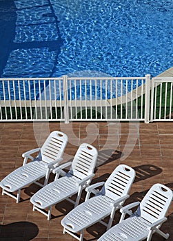 Four recliners in the pool