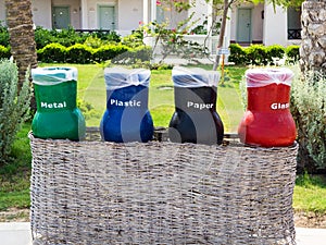 Four recycle bins for waste segregation (glass, paper, metal and plastic). Ecology and recycling concept