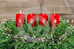 Four red burning candles Advent decoration Christmas tree