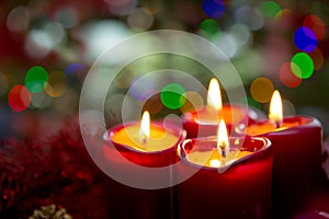 Four red candles for Advent. Christmas background.