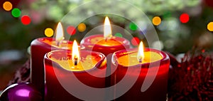 Four red candles for Advent. Christmas background.