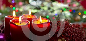 Four red candles for Advent. Christmas background.