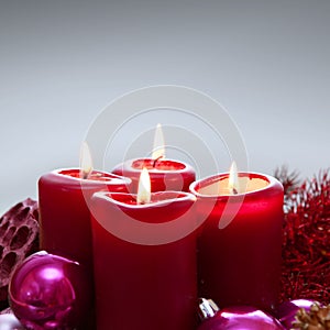 Four red candles for Advent. Christmas background.