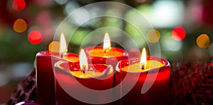 Four red candles for Advent. Christmas background.