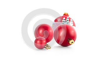 Four red christmas ball decorations against white background