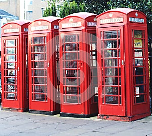 Four red phones booths.