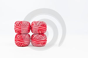 Four red sewing threads as wallpaper or background
