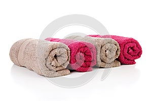 Four rolled colorful towels