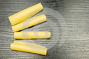 Four rolls of yellow cheese.