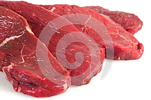 Four rump steaks, close-up photo