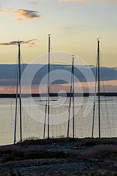Four sailingboat masts sunset Stockholm archipelago photo