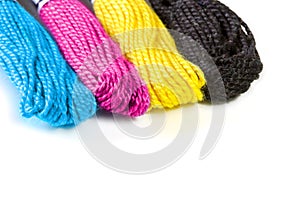 Four sawing silk threads in the prepress colors cmyk