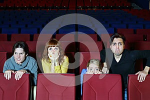 Four scared friends see movie in cinema theater