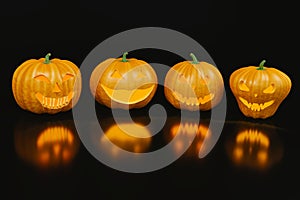 Four scary halloween pumpkins with reflection on the black background