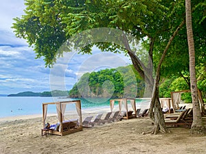 Four Seasons Resort Costa Rica at Peninsula Papagayo. Beach in front of the pacific ocean. Long and green trees on a clear day.