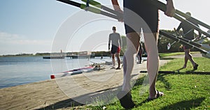 Four senior caucasian men and women preparing rowing boat in a river