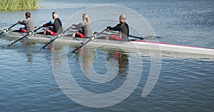 Four senior caucasian men and women rowing boat on a river