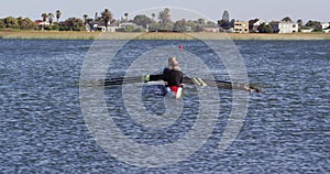 Four senior caucasian men and women rowing boat on a river