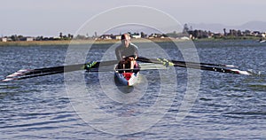 Four senior caucasian men and women rowing boat on a river