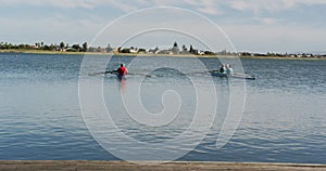 Four senior caucasian men and women rowing boat on a river