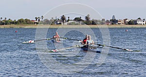 Four senior caucasian men and women rowing boat on a river