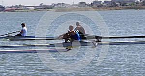 Four senior caucasian men and women rowing boat on a river