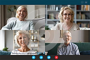 Four seniors people involved at group videocall laptop webcam view