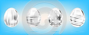 Four silver eggs on the sky blue background. Isolated objects for Easter. Dots and stripes ornate