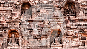 Four Sitting Buddha carved in Stone at Borobudur