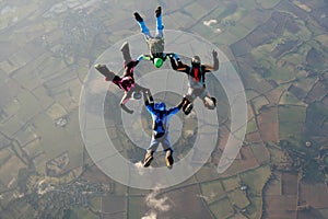 Four skydivers doing formations