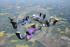 Four skydivers in freefall photo