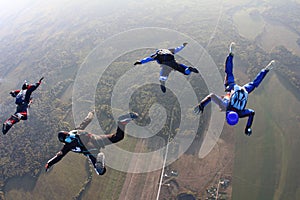 Four skydivers in the sky.