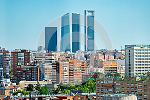 Four skyscraper towers of Madrid emerging among the buildings of the city, Spain. photo