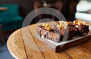 Four slices of chocolate cake sitting on a bakery table