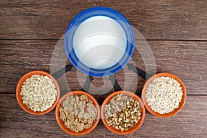 Four small bowls with different cereals and bowl with milk, business strategy, decision making, choice.