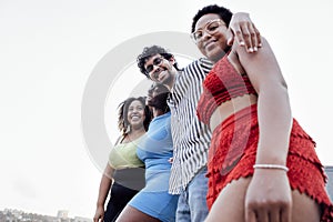 Four smiling mixed race friends standing and looking down at camera