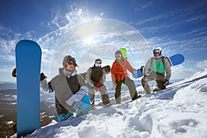 Four snowboarders at ski slope